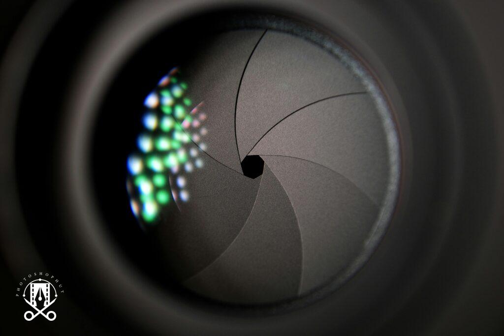 Detailed image of a camera lens aperture showing mechanical blades.